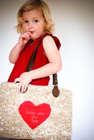 Young girl carring an oversize crochet handbag