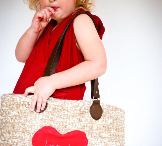 Young girl carring an oversize crochet handbag